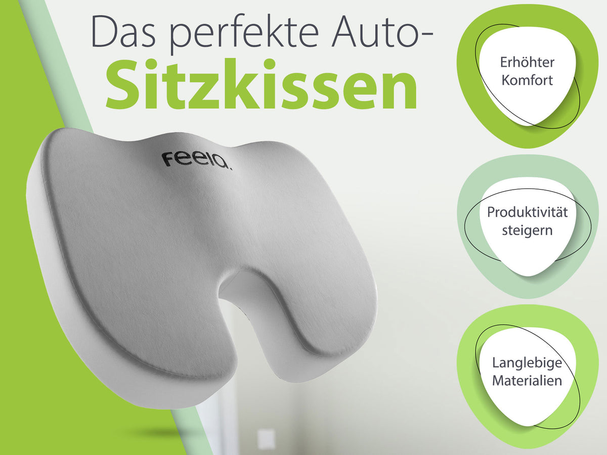 Werbegrafik für das feela® Auto-Sitzkissen, betitelt als 'Das perfekte Auto-Sitzkissen'. Das Bild zeigt das silberne ergonomische Kissen vor einem grünen und weißen Hintergrund mit drei Highlights: 'Erhöhter Komfort', 'Produktivität steigern' und 'Langlebige Materialien' in grünen Kreisen dargestellt.